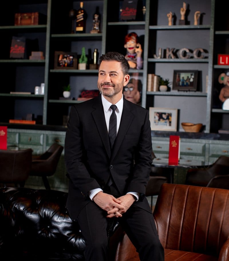 Man in suit sitting in stylish interior.