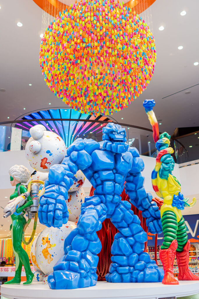 Colorful balloon art installation featuring character figures and a large sphere.