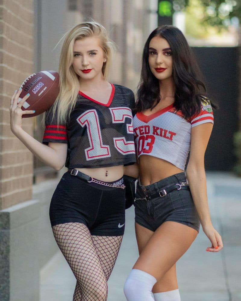 Two women in football-themed outfits posing.