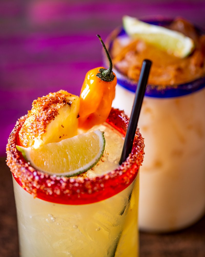 Spicy margarita with chili pepper and lime garnish.