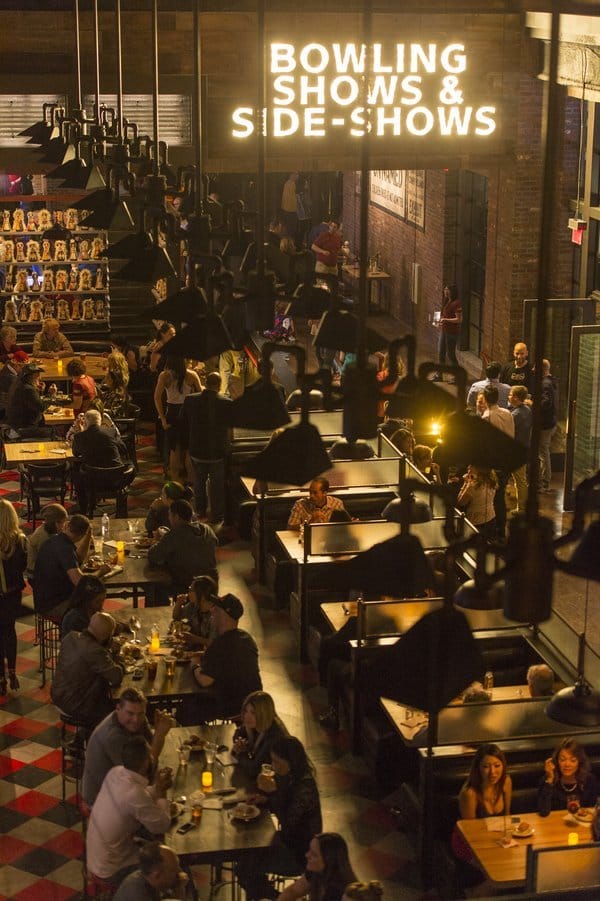 Overhead view of a crowded bar with tables and people.