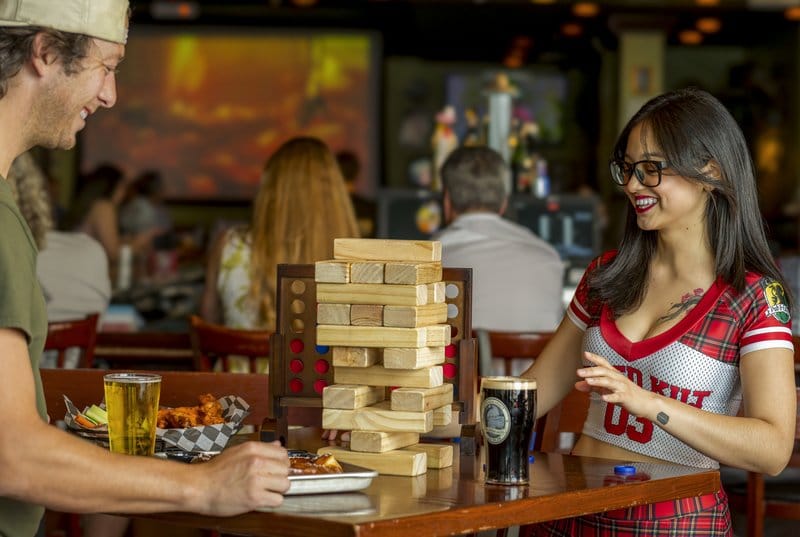 People playing Jenga in a bar.