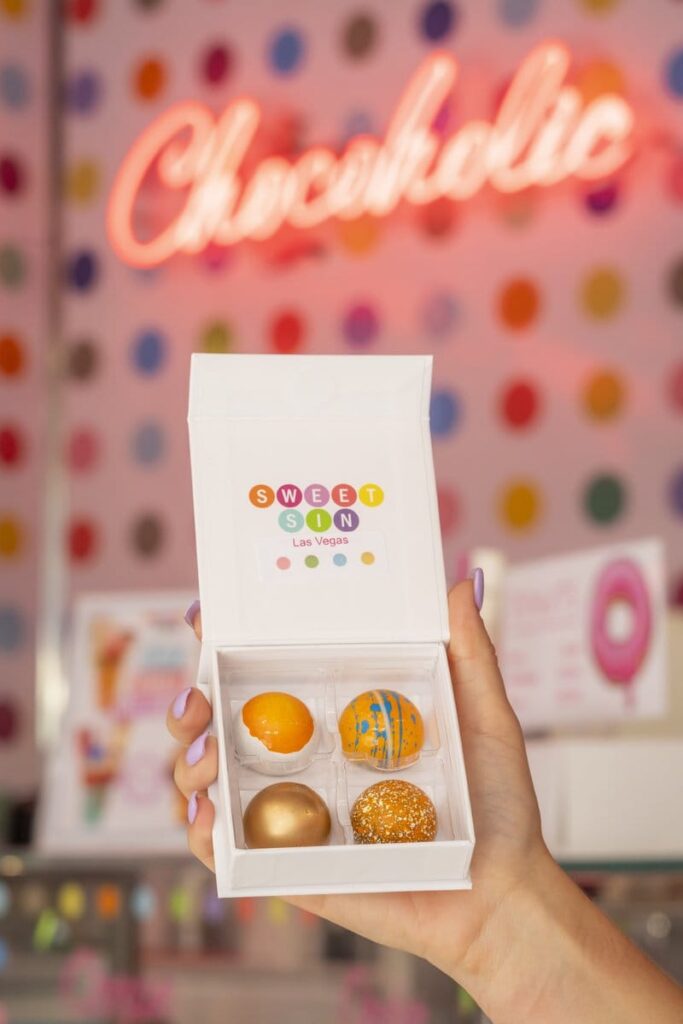 Box of four gourmet doughnuts.