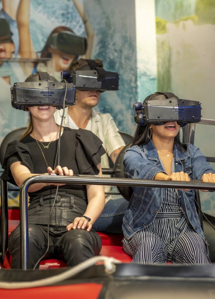 People wearing VR headsets on a ride.