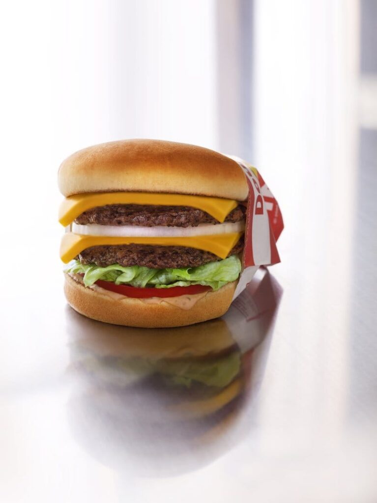 Double cheeseburger with lettuce and tomato.