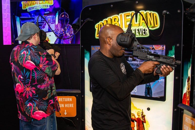 Man playing Zombieland VR game.