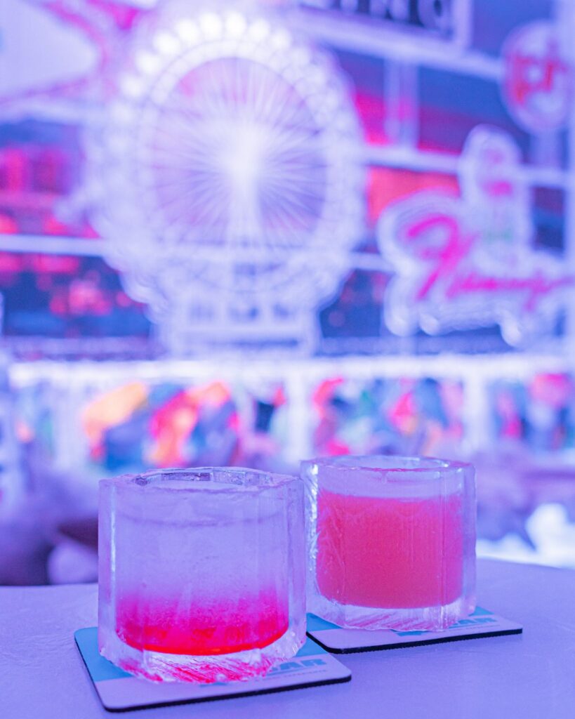 Two colorful drinks with blurry Ferris wheel background.