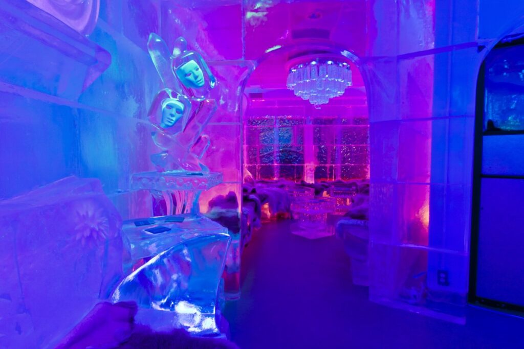 Ice sculpture inside illuminated ice bar.