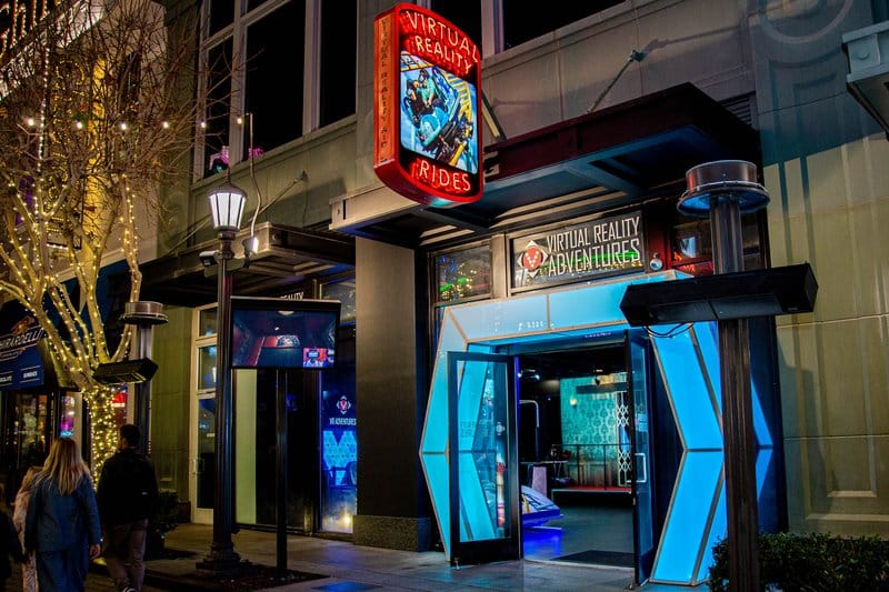 Exterior of a sports bar at night with a glowing sign.
