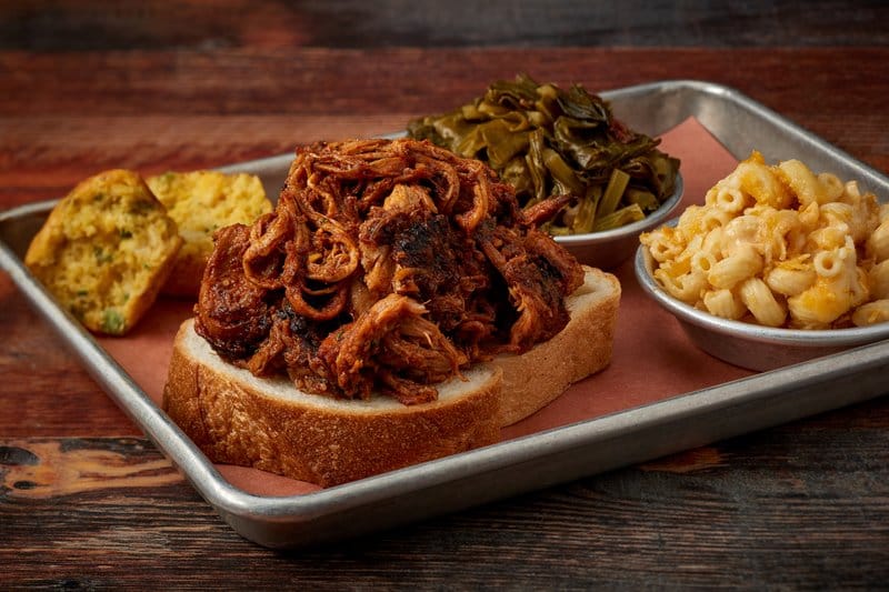 Pulled pork sandwich with sides.