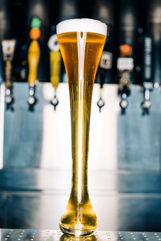 Beer pouring from tap into glass.